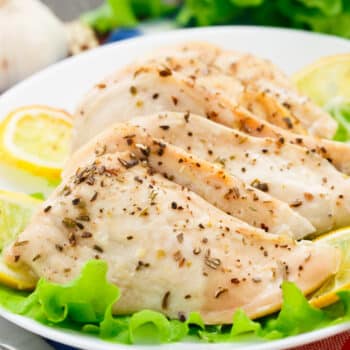 Simple And Perfect Lemon Garlic Chicken Served On A Plate With Lemon And Lettuce