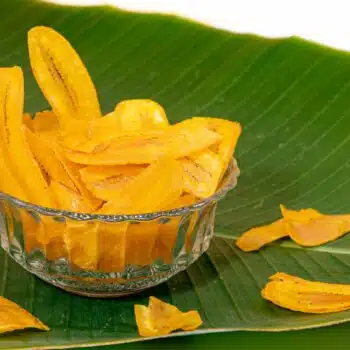 A Bowl Of Healthy Baked Banana Chips On A Banana Leaf